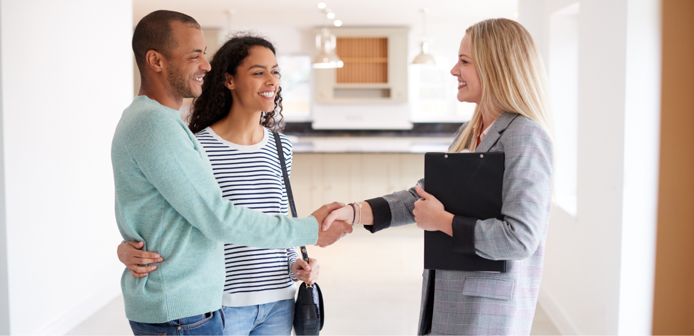 Real estate agents shows a property to a couple