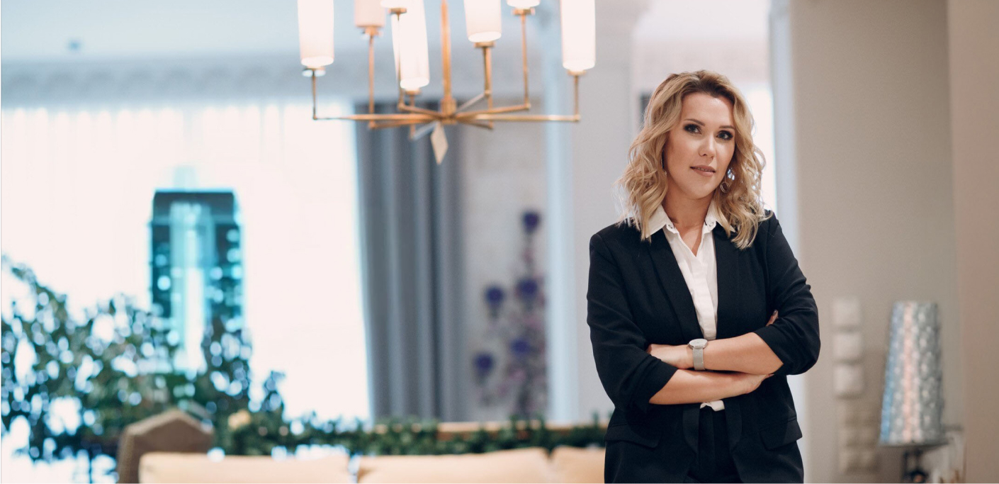 Confident women property practitioner stands with her arms folded