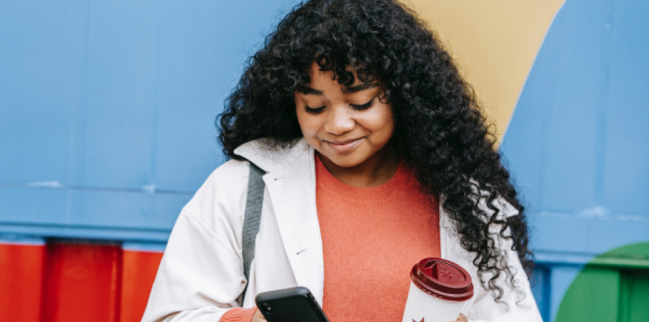 Millennial woman browses online with her smartphone