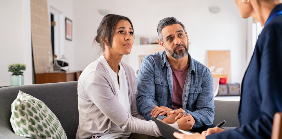 Concerned couple talks to a real estate professional