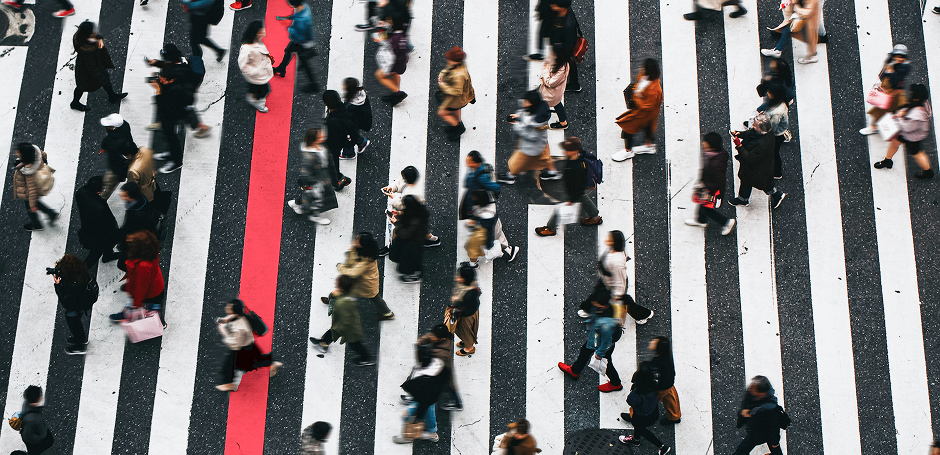 Crowd of people walking on a zebra crossing
