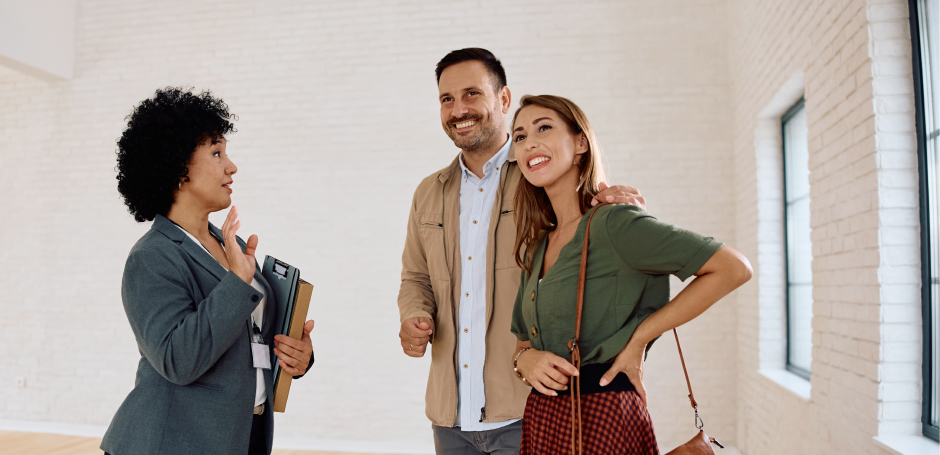 Property practitioner talks to couple during a home viewing