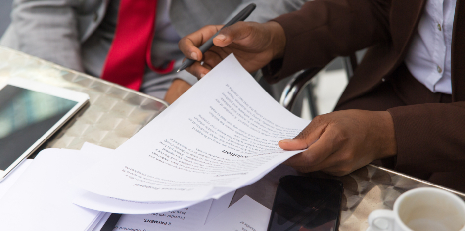 Man holding a pen and document
