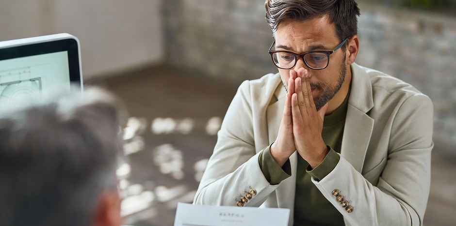 A man looks concerned about possible rental property scams.