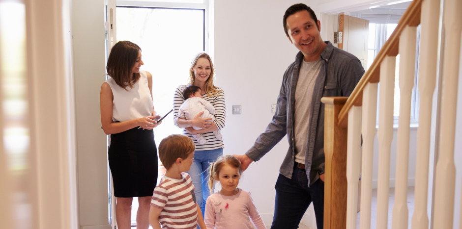 Property practitioners shows a family a home