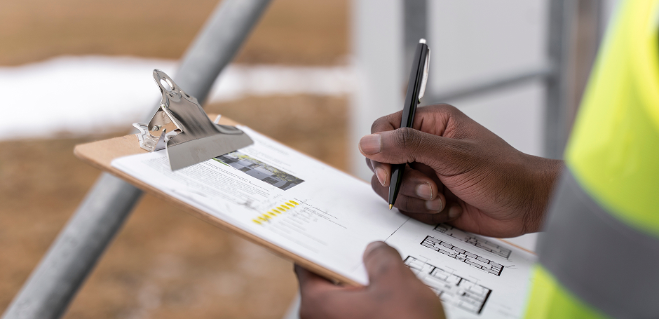 Municipal worker writes on a clipboard 