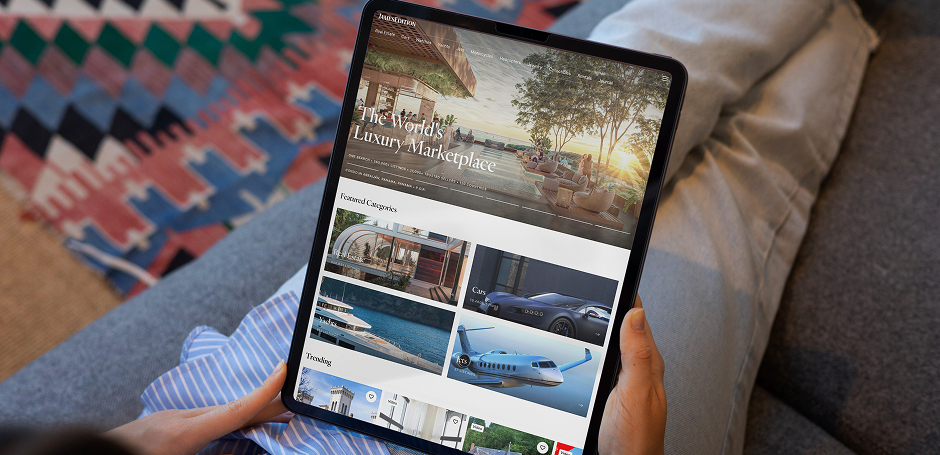 Person views JamesEdition property portal on a tablet