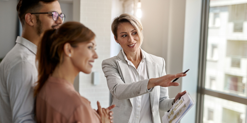 A real estate agent shows a couple a home