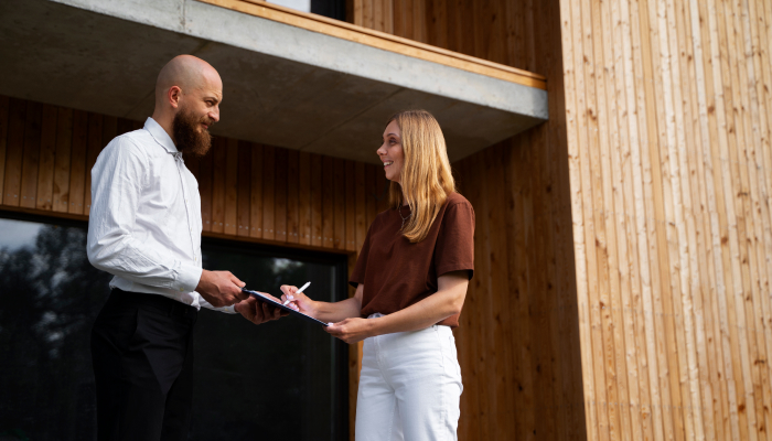 Real estate client signs a document for a property practitioner