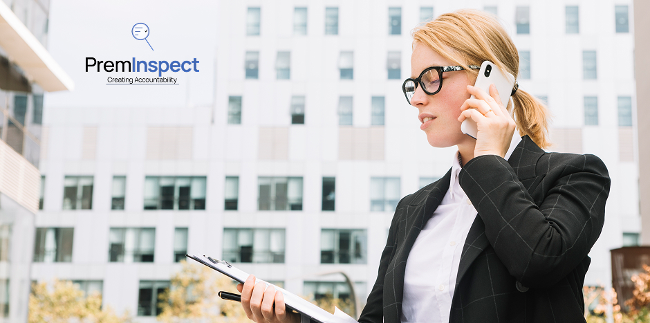 Women property practitioner views an inspection report while talking on the phone