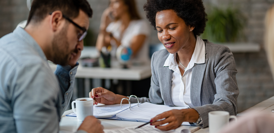 Women property practitioner goes through paperwork with her client