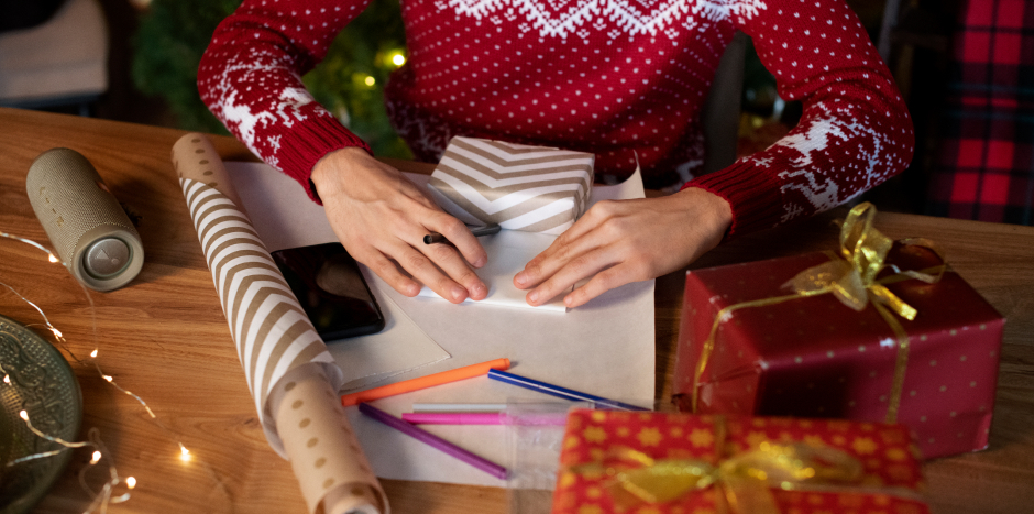 Person wraps a Christmas present