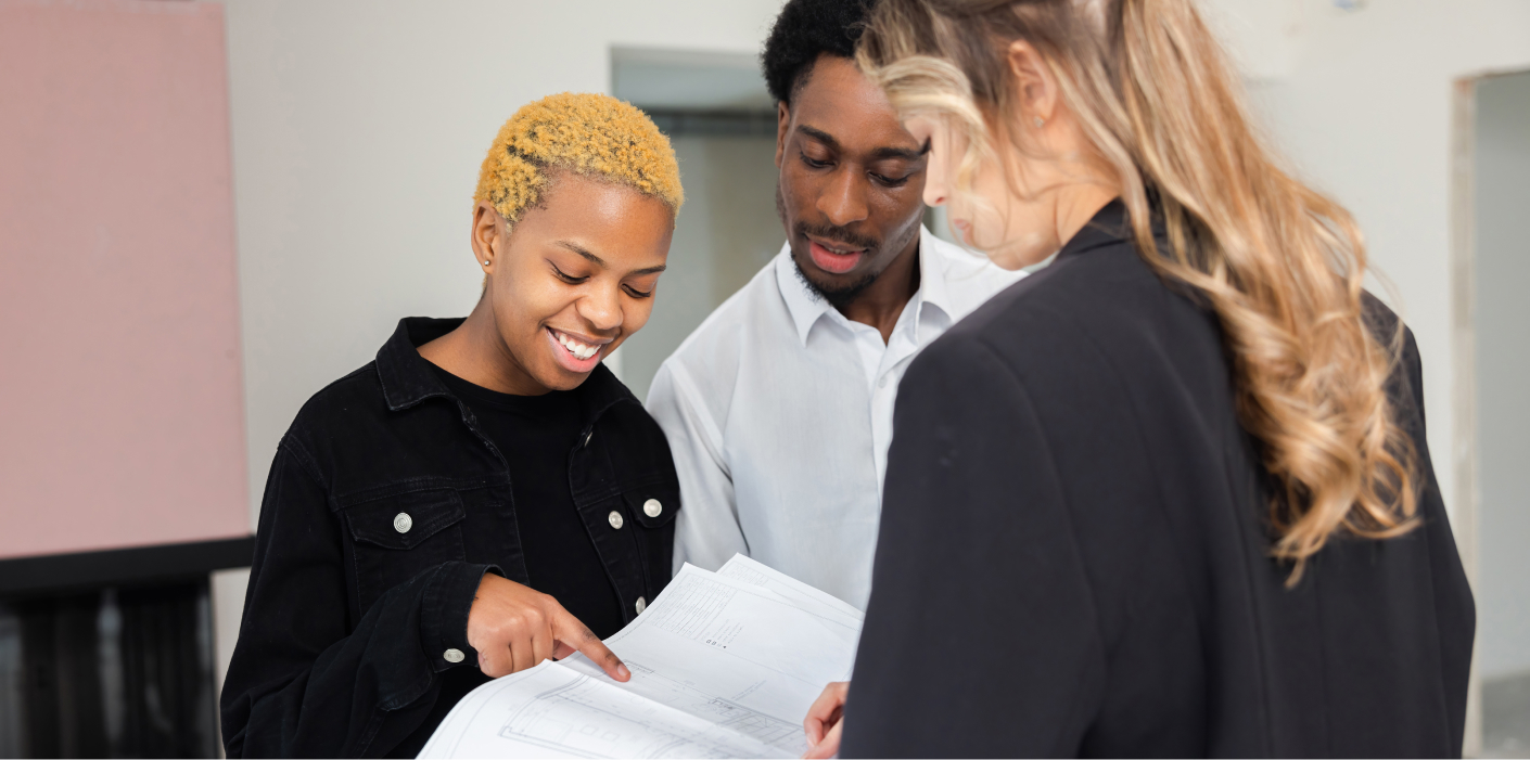 A property practitioner helping young people in South Africa finalise a real estate purchase.